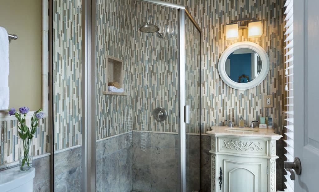 bathroom with tile and small vanity