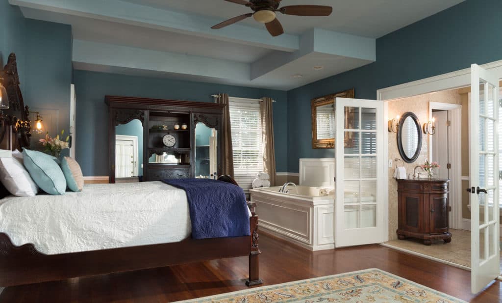 large blue bedroom with tub