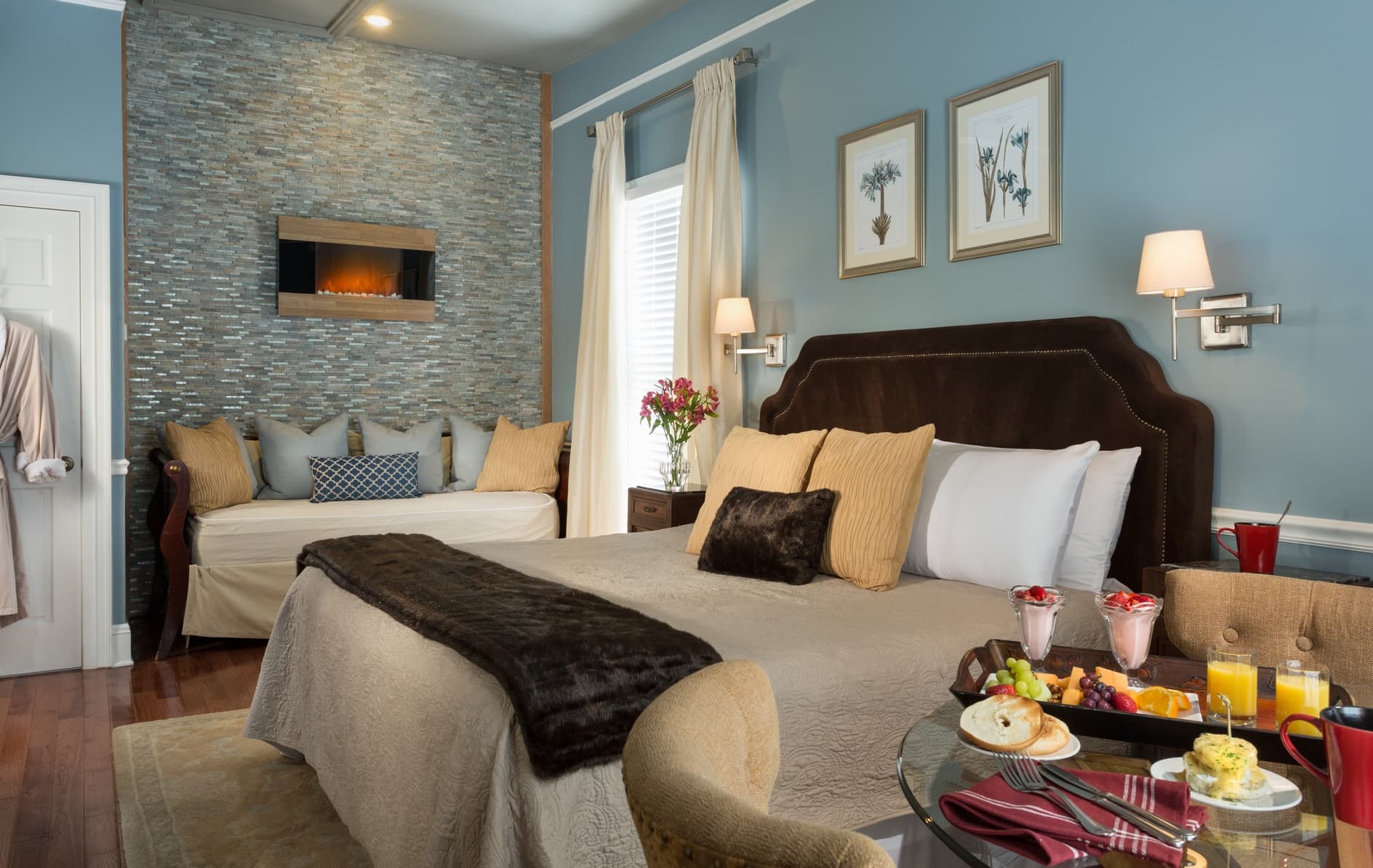 upholstered bed with wall fireplace