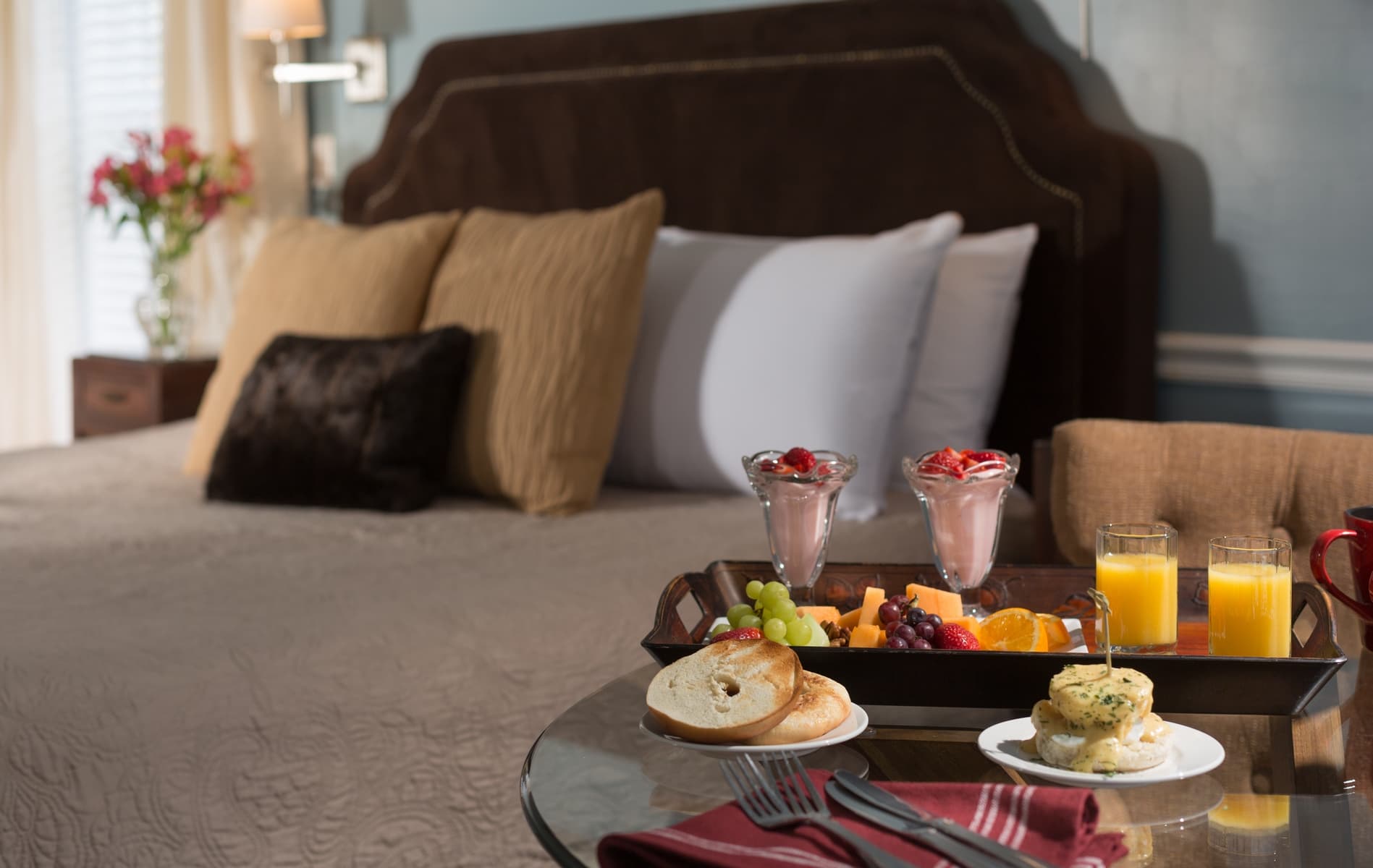 upholstered king sized bed with breakfast in front