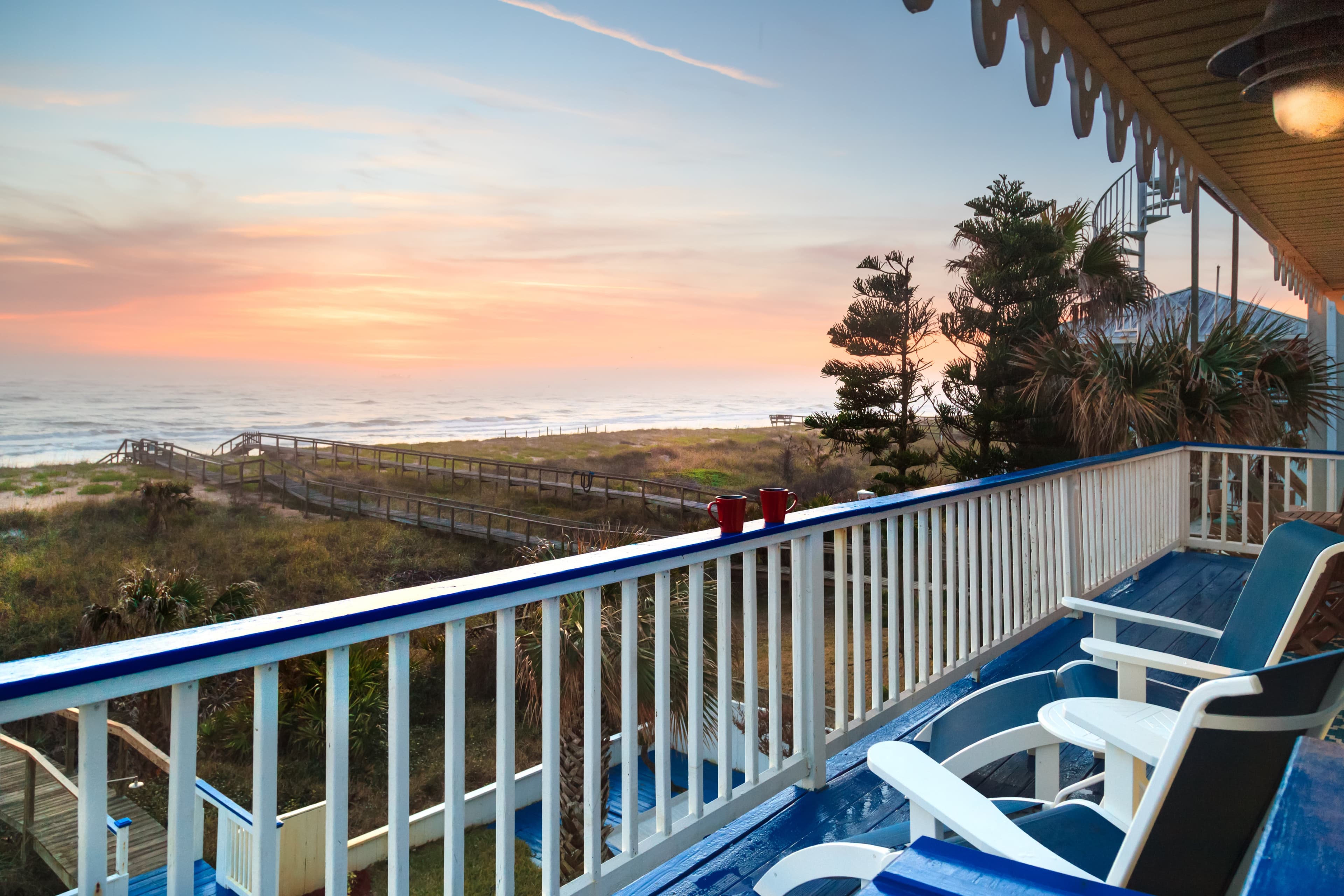 outside deck with two chairs and water view