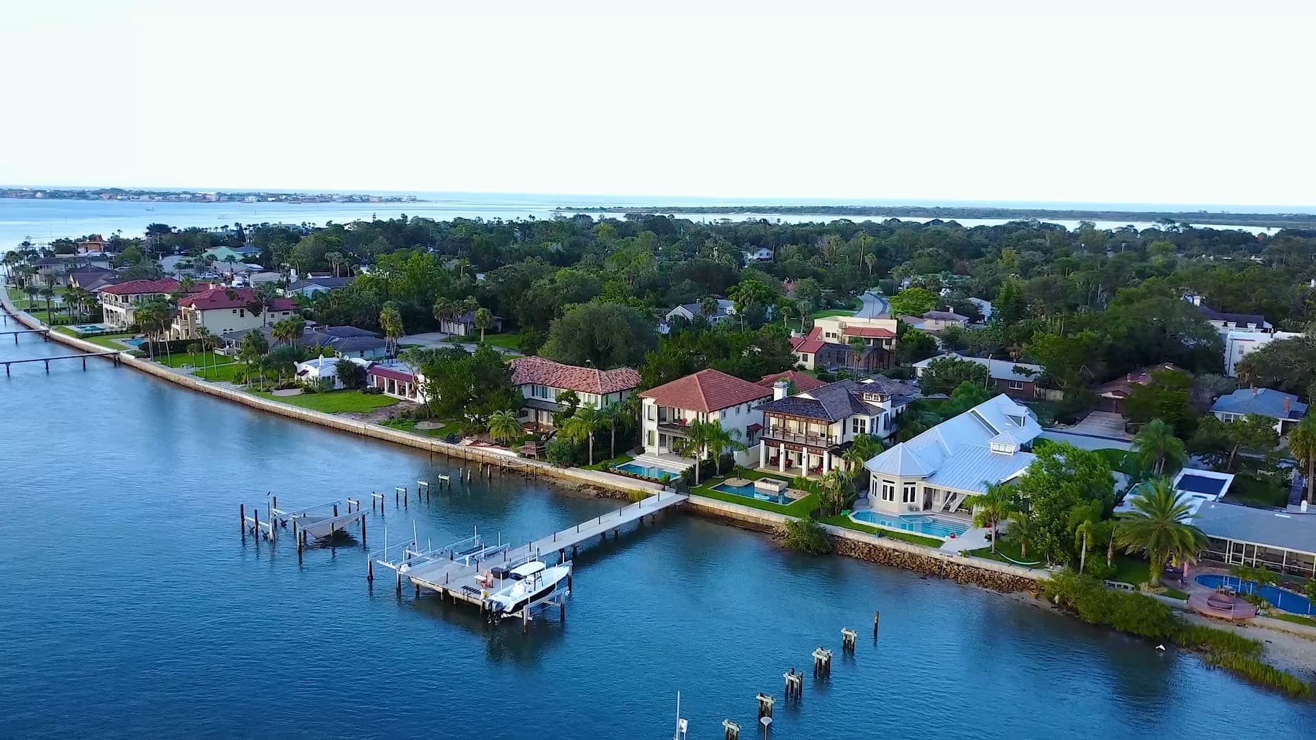 Aerial view of waterfront homes along a tranquil bay.
