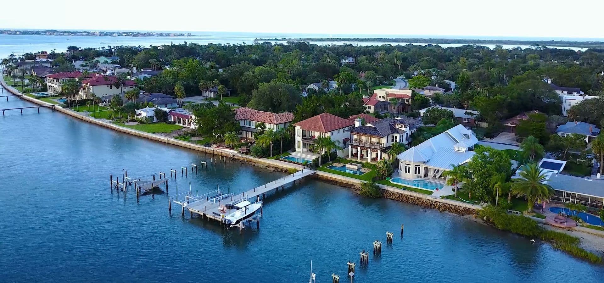 Aerial view of waterfront homes along a picturesque shoreline.