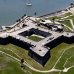 view of castillo de san marcos stone fortress on st augustine waterfront surrounded by green lawns