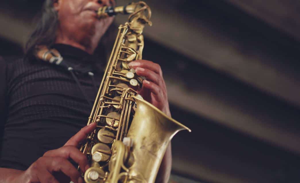 Close up view of a man playing a saxophone