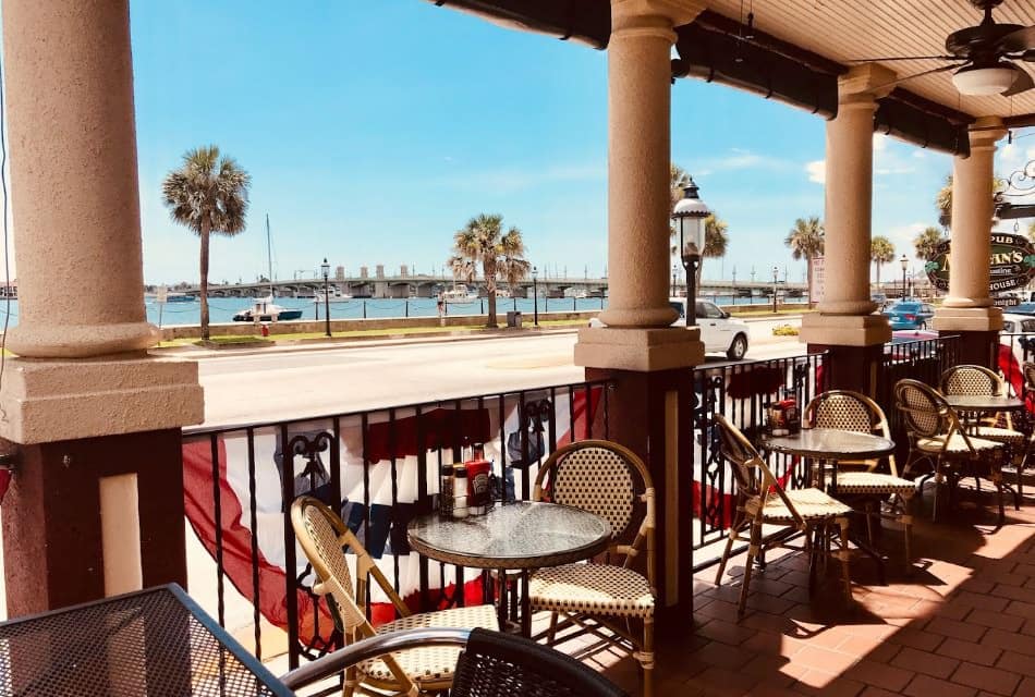 Restaurant's patio seating with tables and chairs with a view of the water