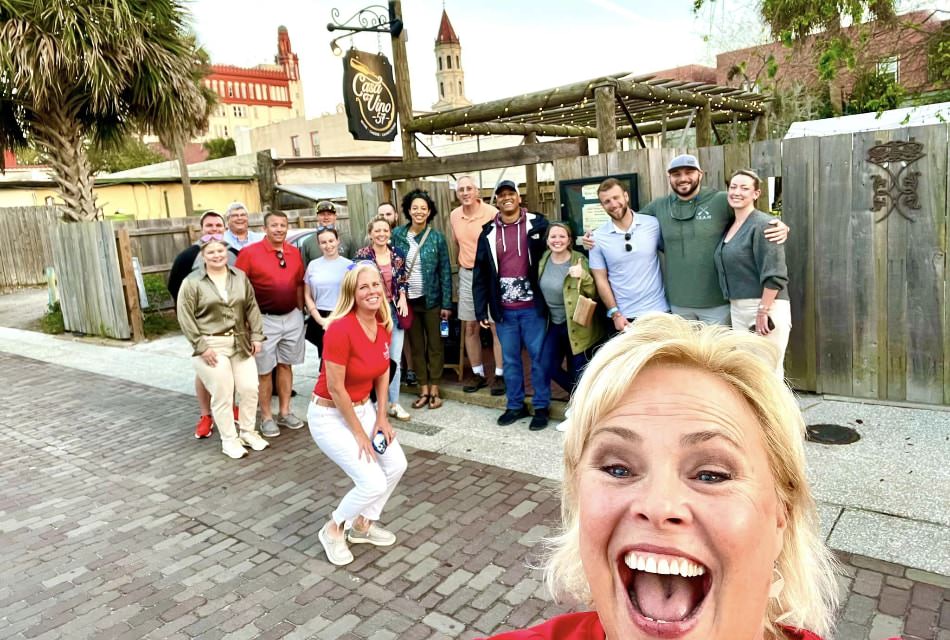 Group of people posing for the camera outside in front of a restaurant